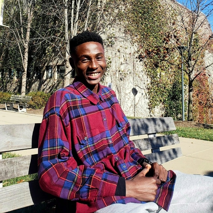Joshua Osakwe Joshua Osakwe sitting on a bench outside