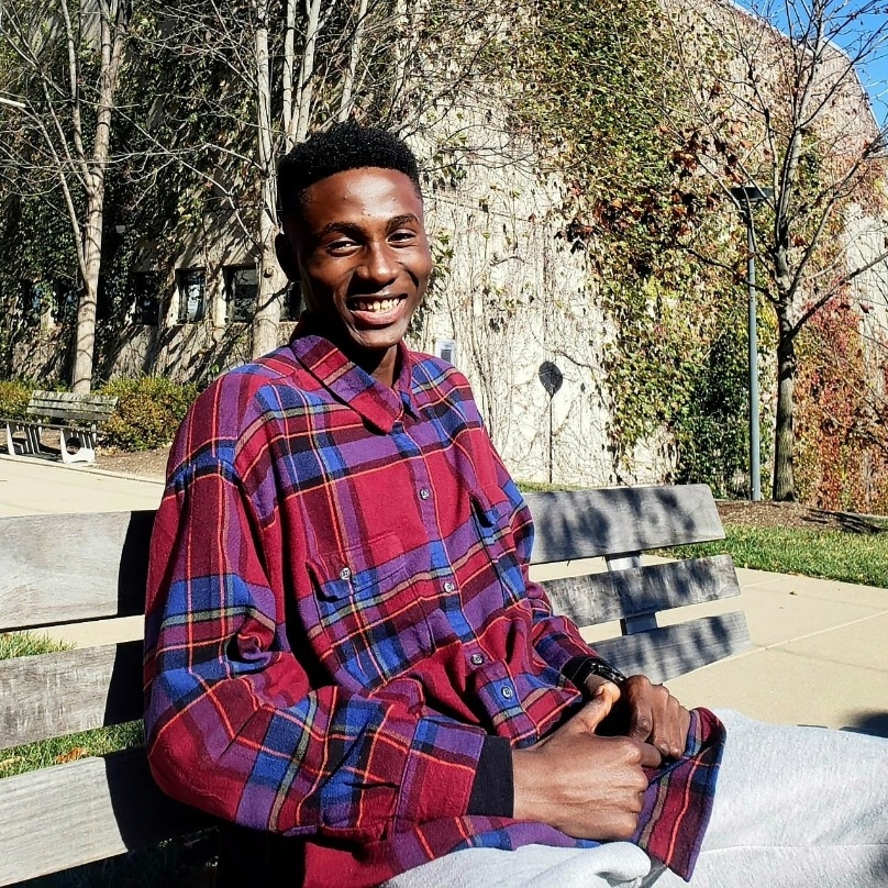 Joshua Osakwe Joshua Osakwe sitting on a bench outside