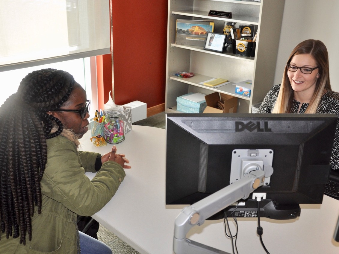 Academic advisor looking at a course schedule with a student