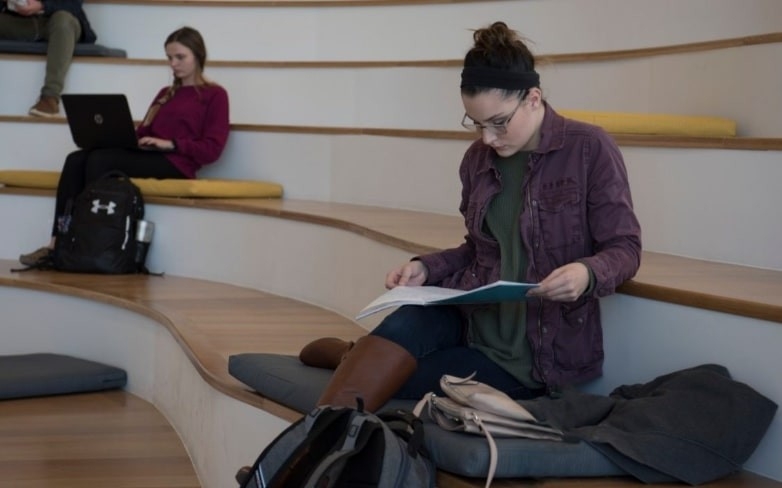 Woman studying on set of stairs