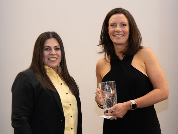Angela Healy Jones holding award with Christina Roybal