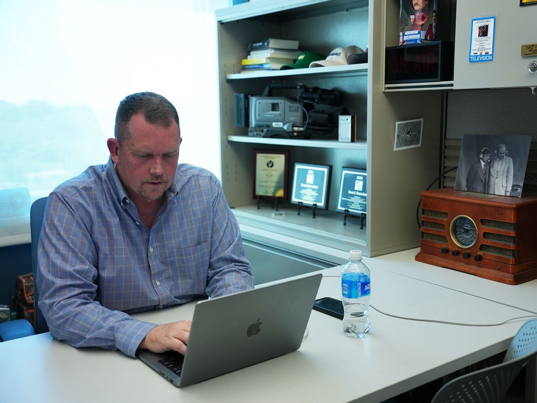 Wes Akers sitting at desk